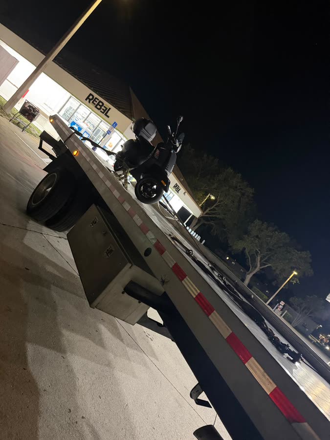 Scooter loaded on the flatbed at night